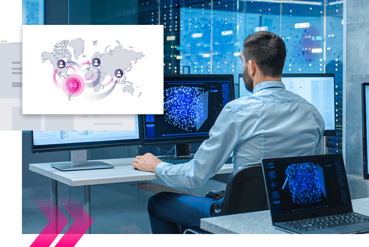 A man sits at a desk in a modern office, viewing data visualizations on multiple monitors—one screen highlights Digital Impersonation protection with a graphic of a global network.